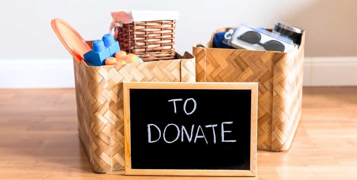 garage decluttering sorting items into piles keep donate trash boxes floor