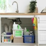 under sink cabinet clutter vs organized pull out bins cleaning supplies