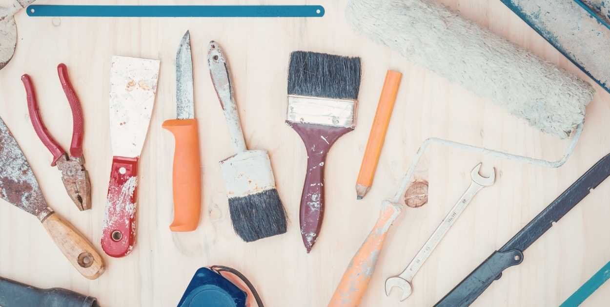 cabinet painting supplies laid out rollers paint sandpaper tape real home setup