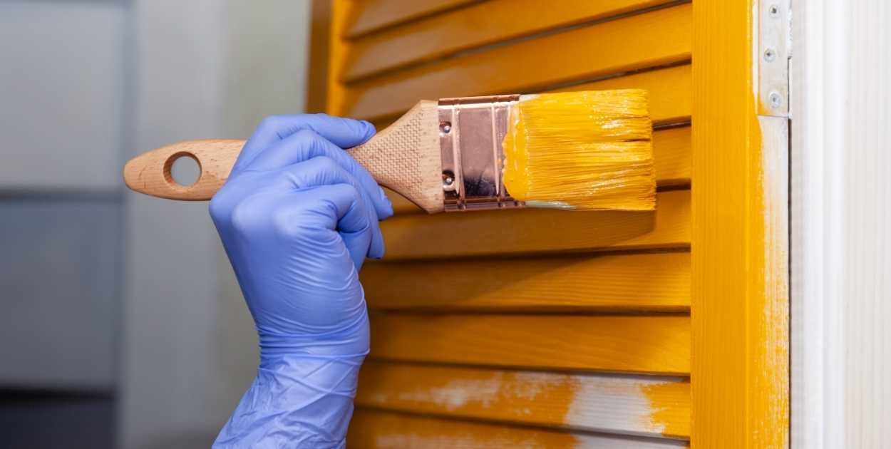 applying clear topcoat on painted cabinet door brush
